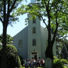 A front view of the Setauket Presbyterian Church on a busy Sunday morning. The current building dates from 1812, though the location (and graveyard) are original to the 18th century.